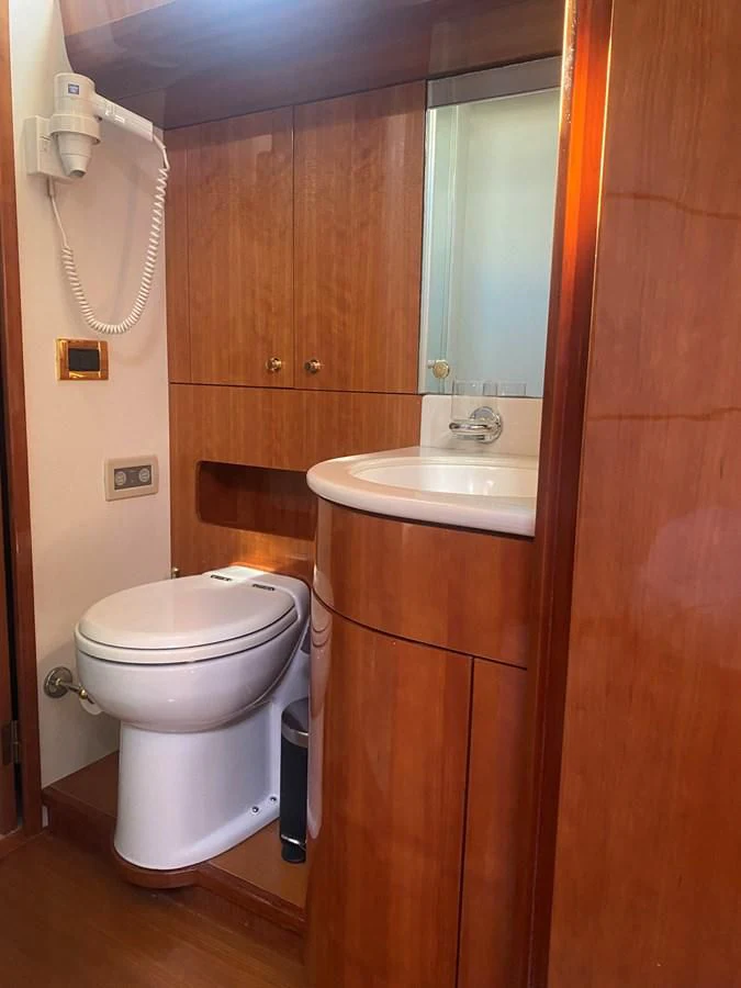 a bathroom with a toilet and sink aboard AMADEUS Yacht for Sale