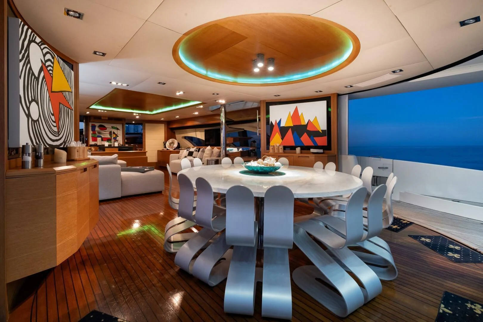 a room with a table chairs and a tv aboard INTERVENTION Yacht for Sale