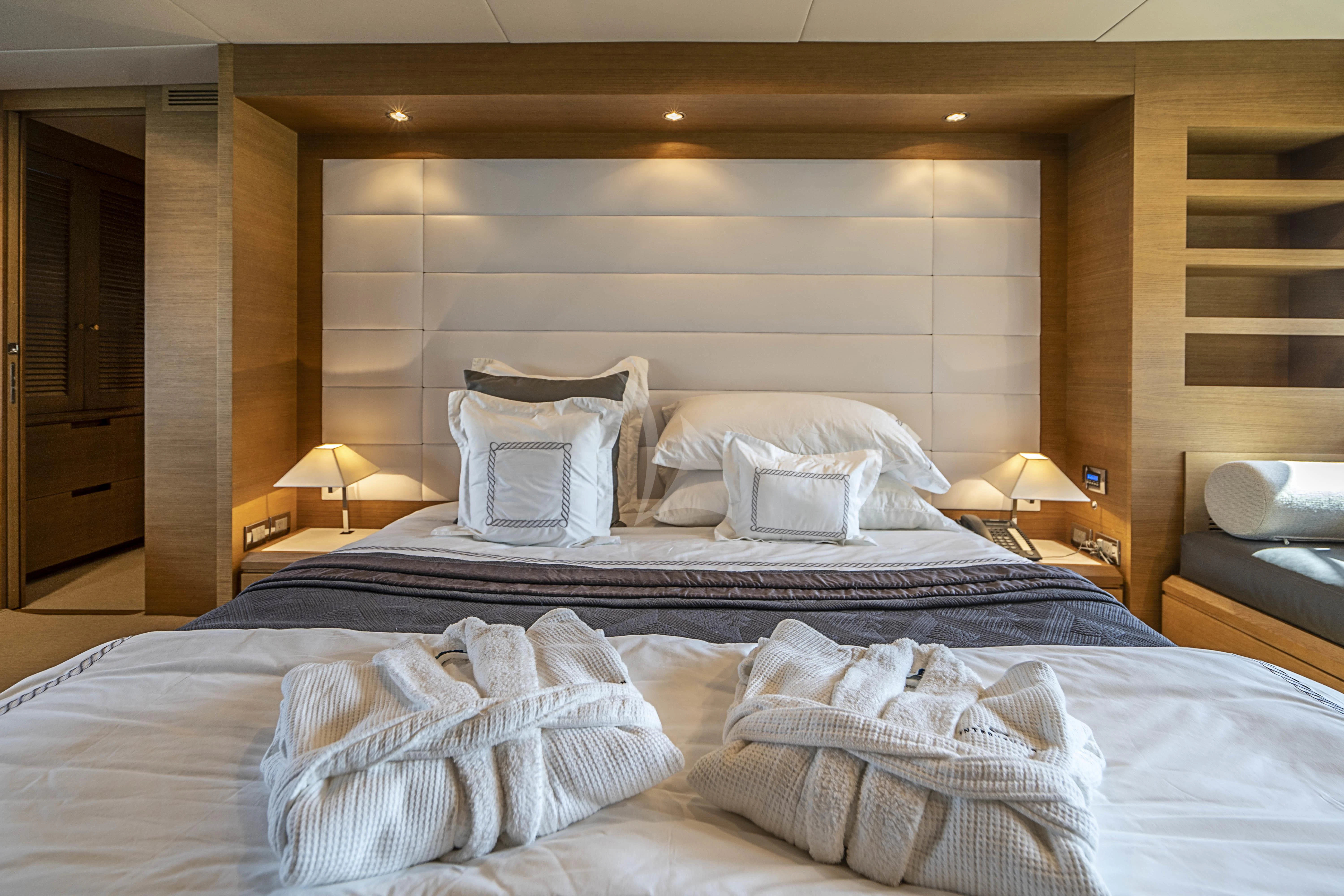 a bed with white sheets aboard INTERVENTION Yacht for Sale