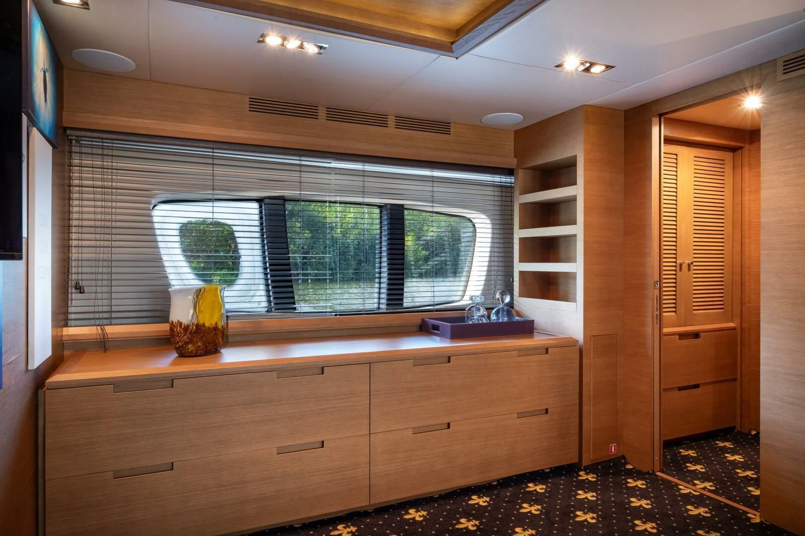 a room with a large window and wood cabinets aboard INTERVENTION Yacht for Sale