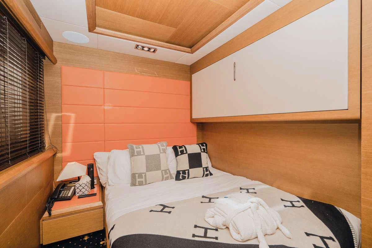 a bed with a white sheet and a white pillow on it aboard INTERVENTION Yacht for Sale