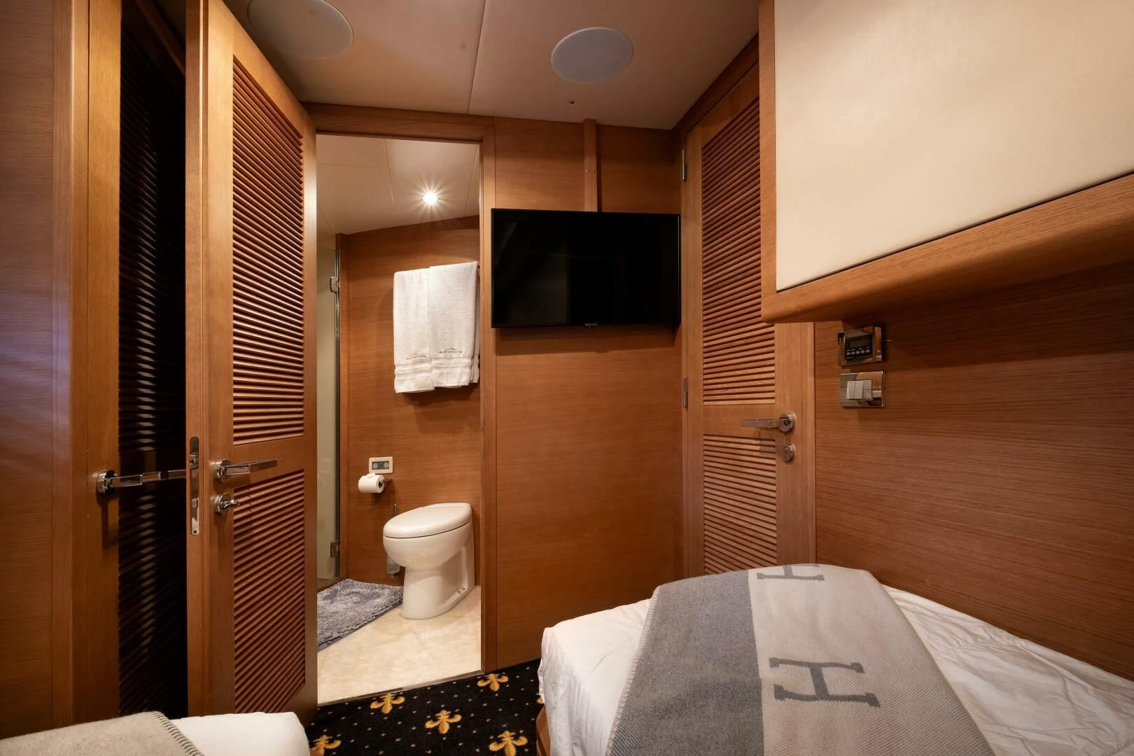 a bathroom with a bed and a closet aboard INTERVENTION Yacht for Sale