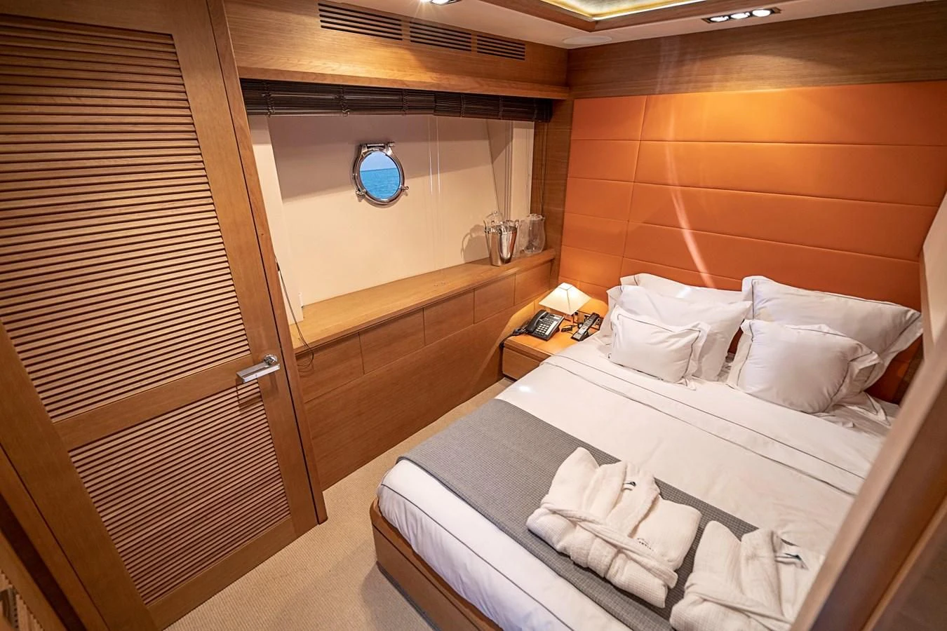 a room with a bed and a window aboard INTERVENTION Yacht for Sale