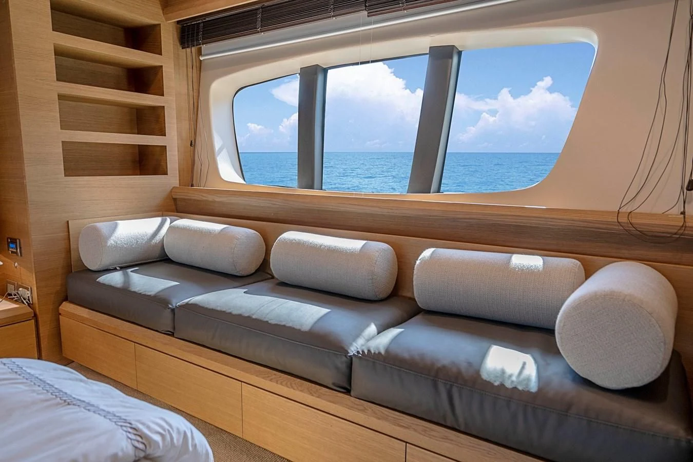 a couch with a window aboard INTERVENTION Yacht for Sale