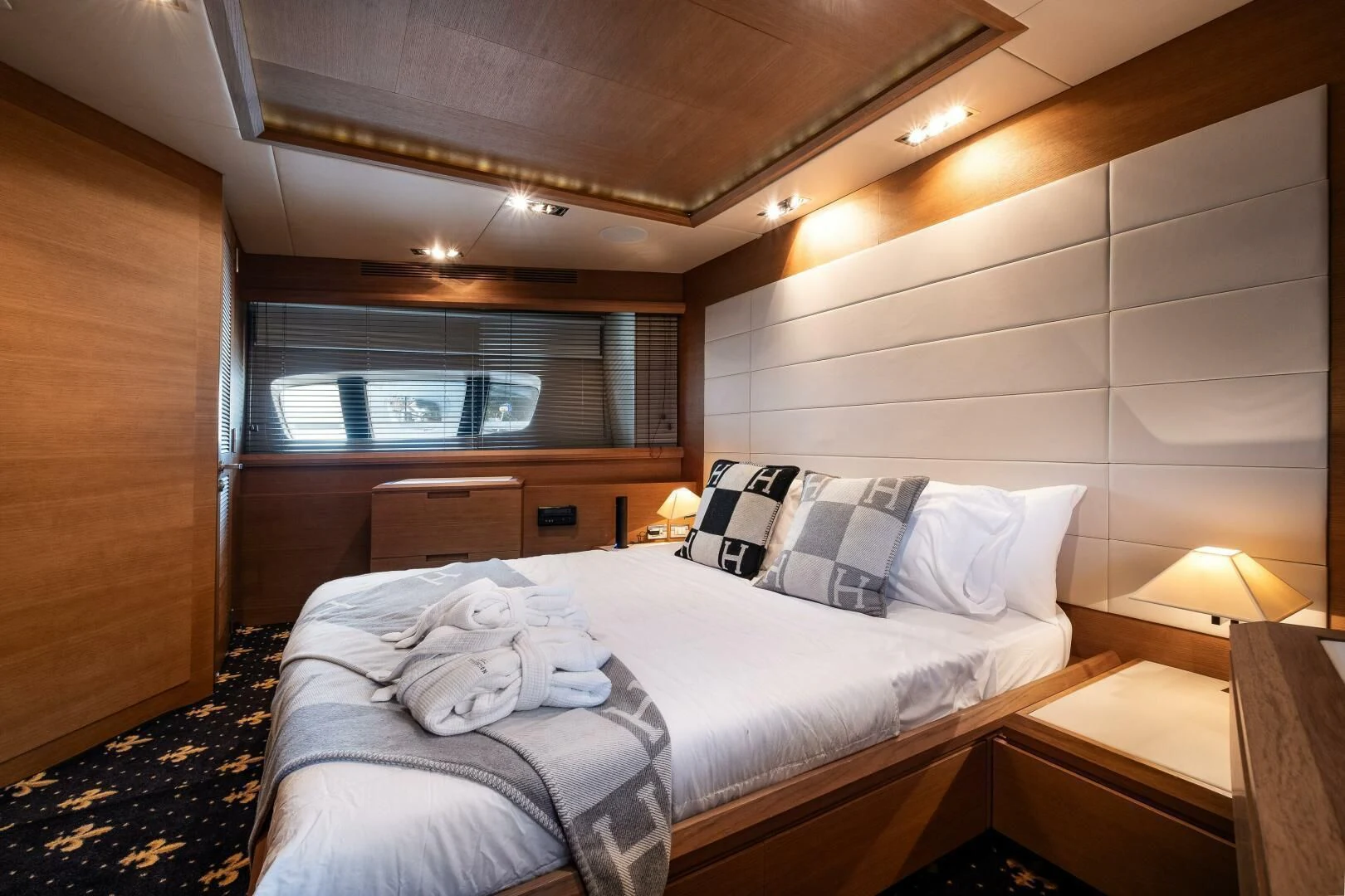 a bedroom with a bed and a desk aboard INTERVENTION Yacht for Sale