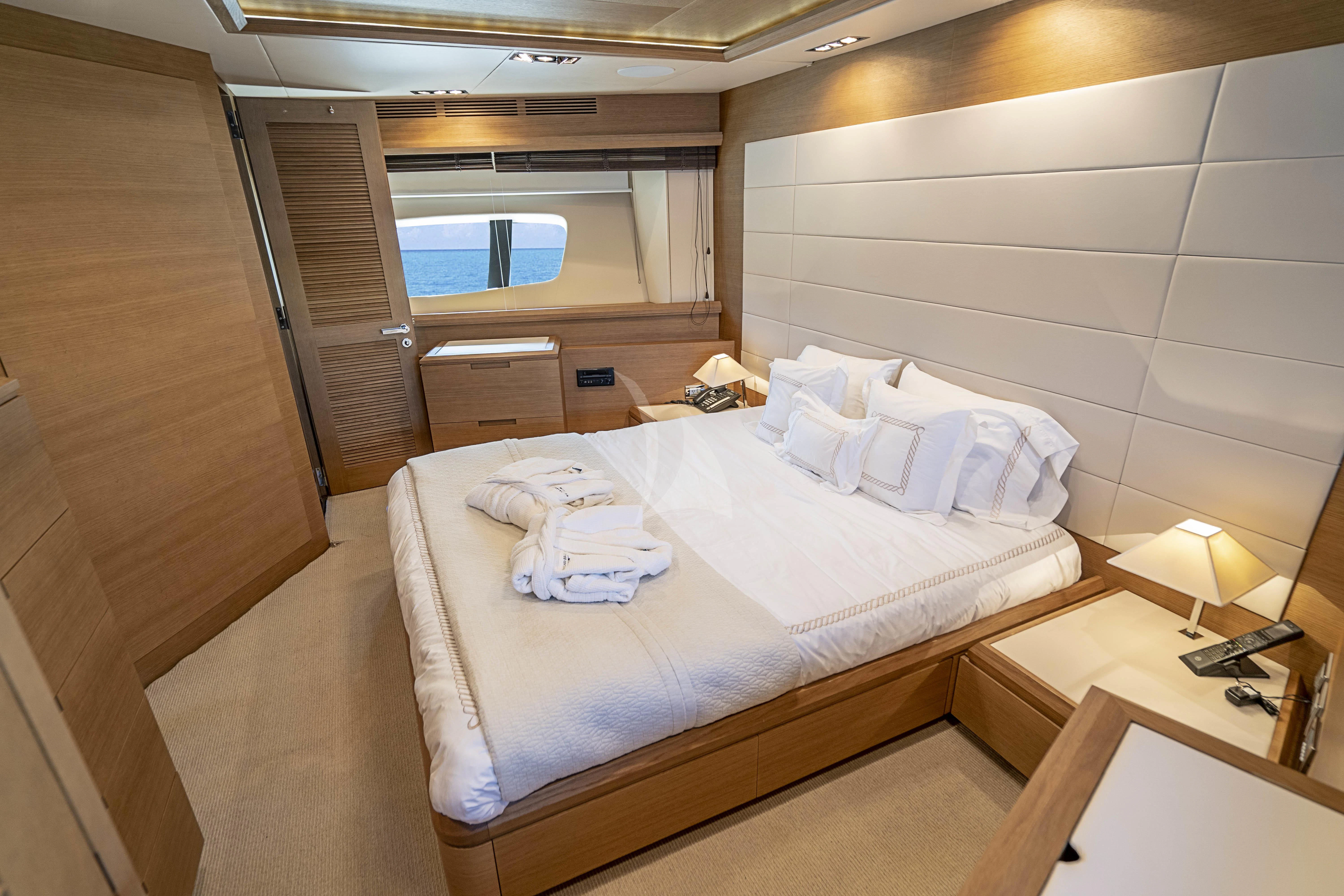 a room with a bed and a window aboard INTERVENTION Yacht for Sale