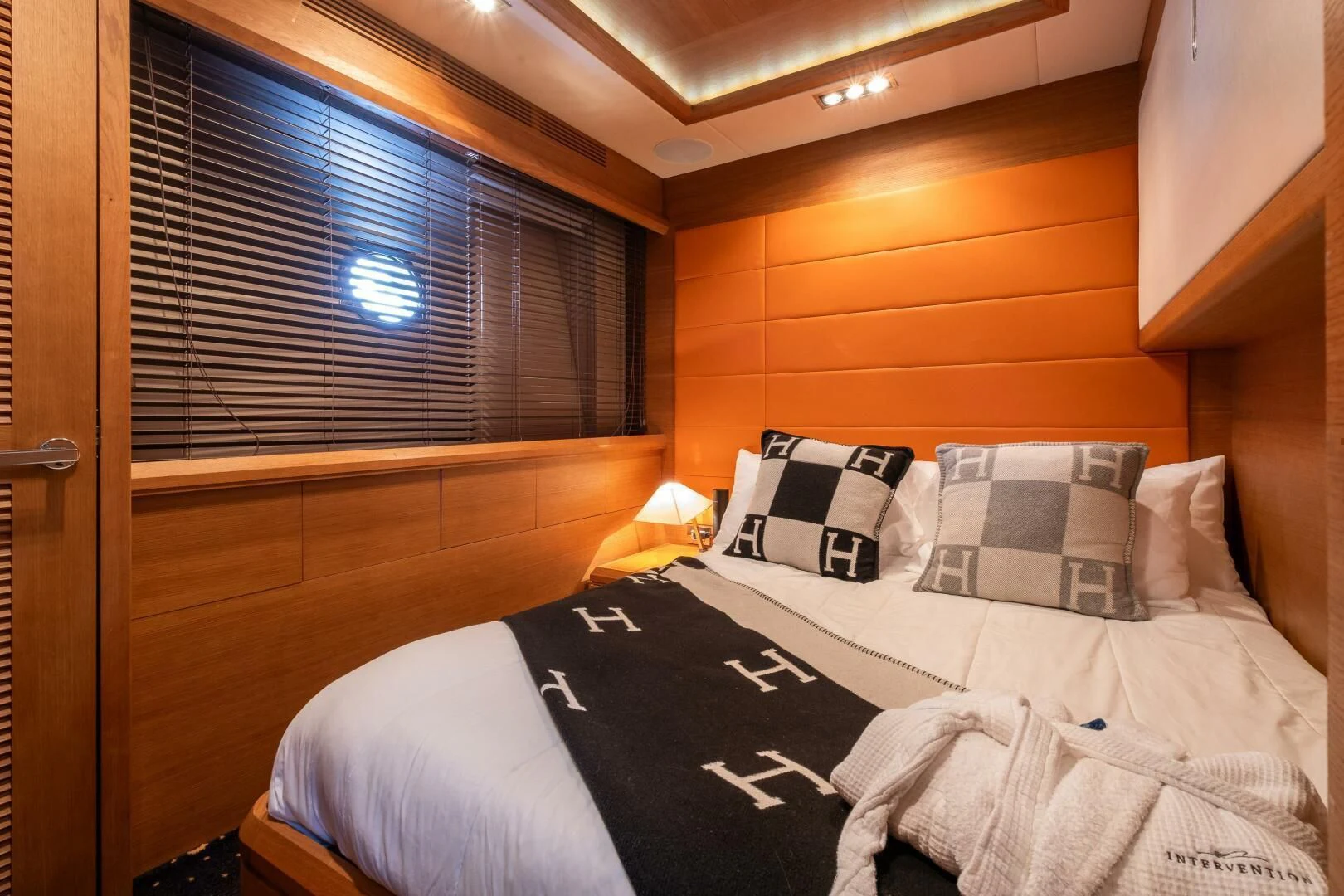 a room with a bed and a window aboard INTERVENTION Yacht for Sale
