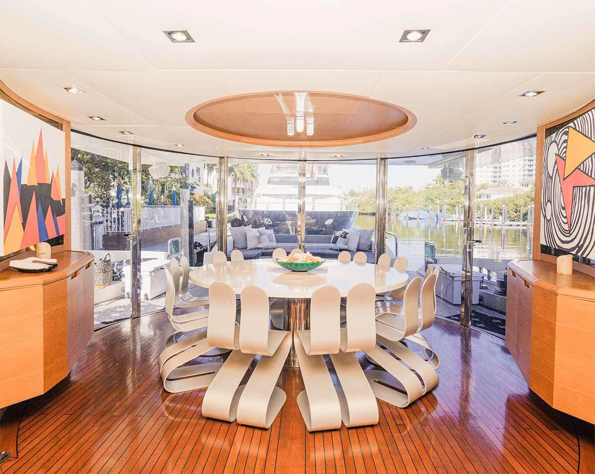a room with a table chairs and a large window aboard INTERVENTION Yacht for Sale
