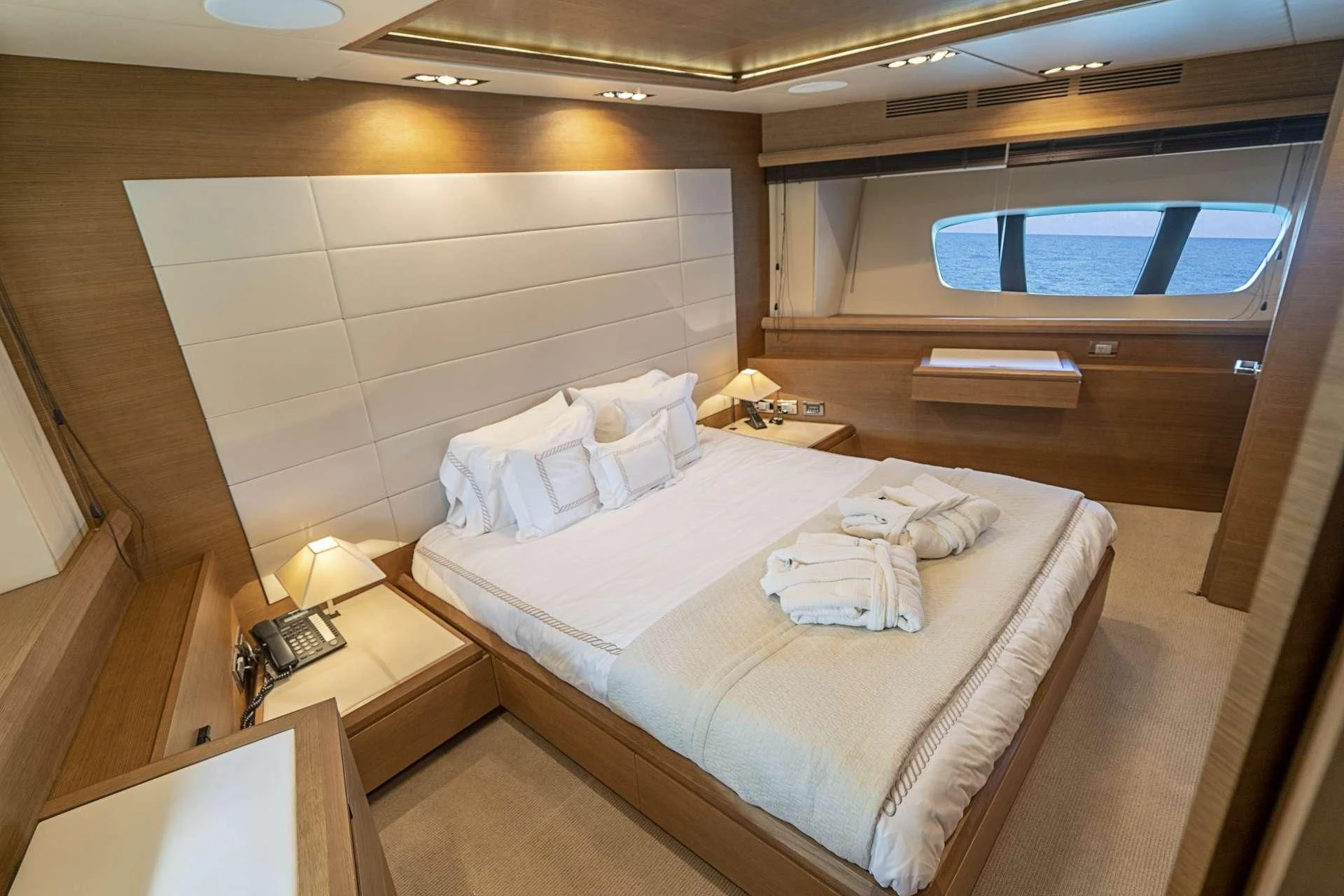 a room with a bed and a window aboard INTERVENTION Yacht for Sale