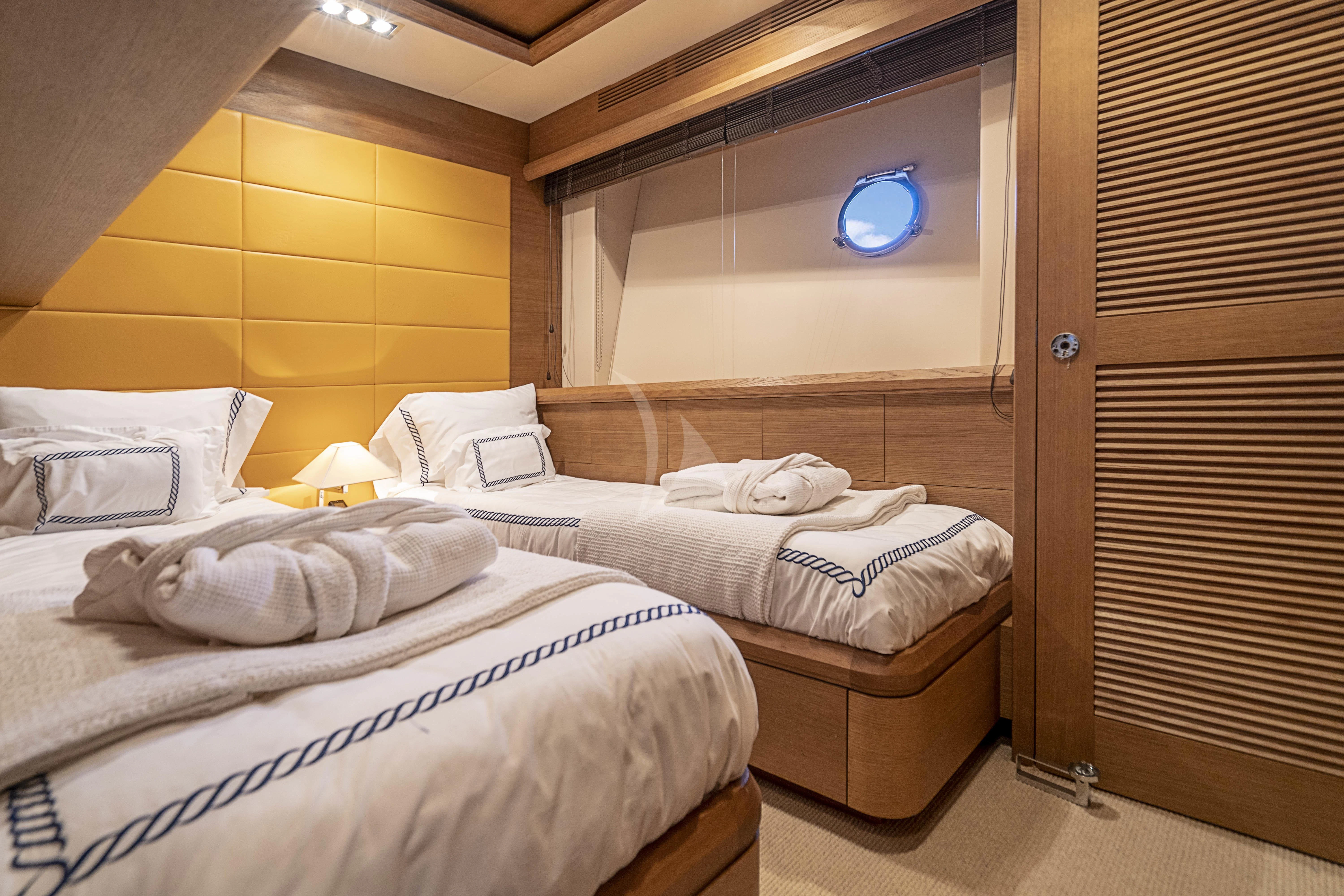a room with beds and a wood door aboard INTERVENTION Yacht for Sale