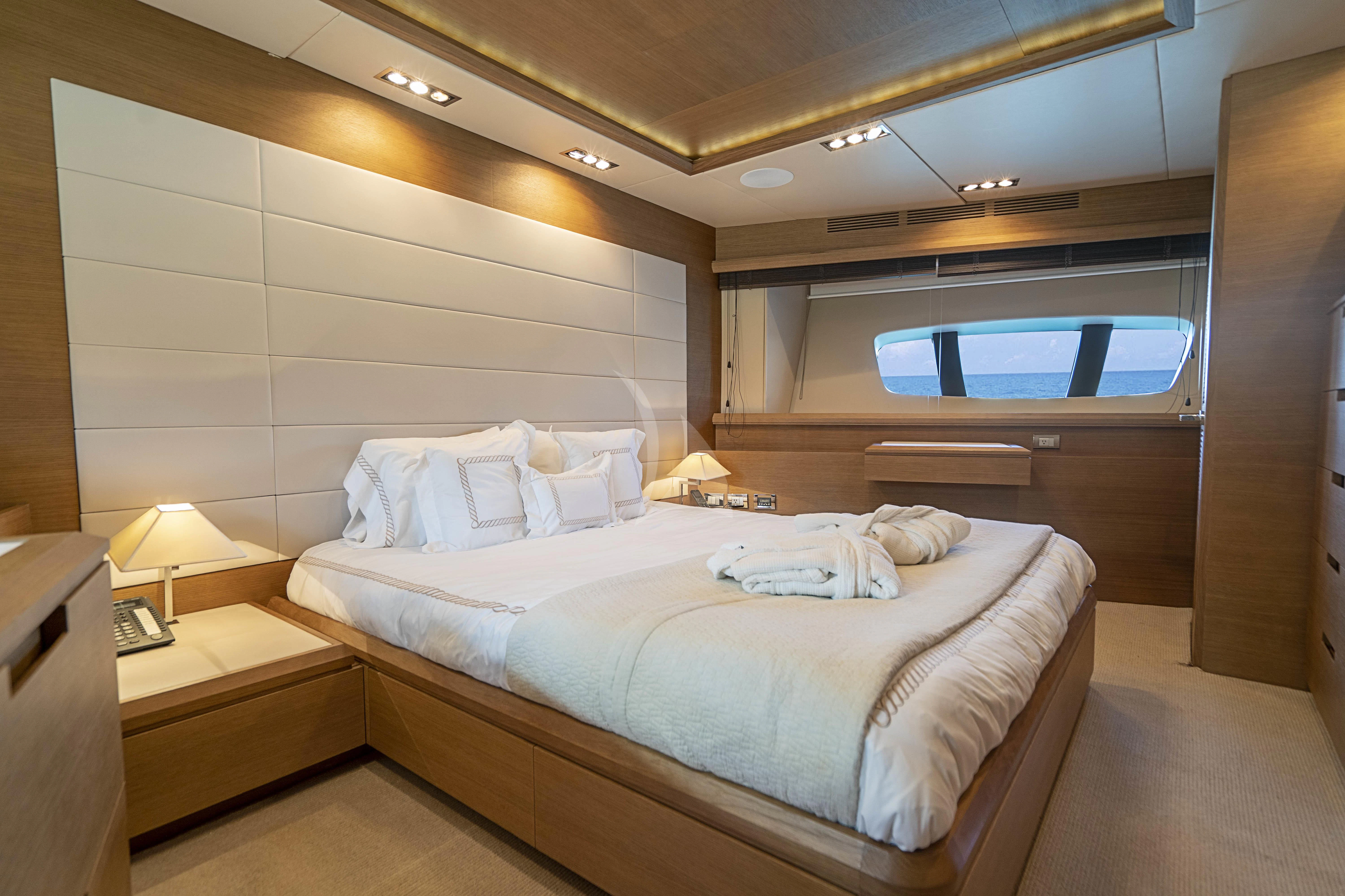 a room with a bed and a window aboard INTERVENTION Yacht for Sale