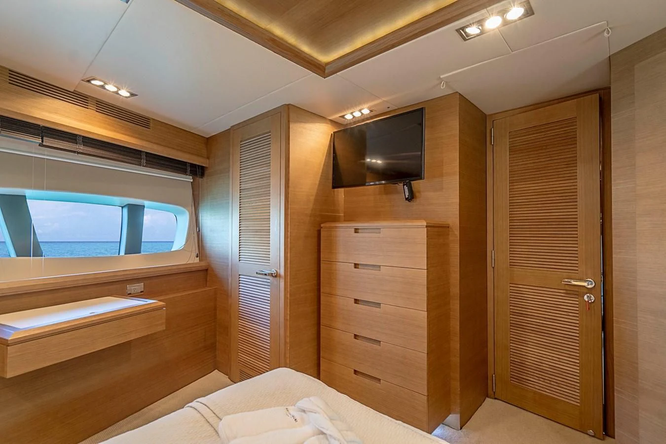 a room with a bed and a television aboard INTERVENTION Yacht for Sale