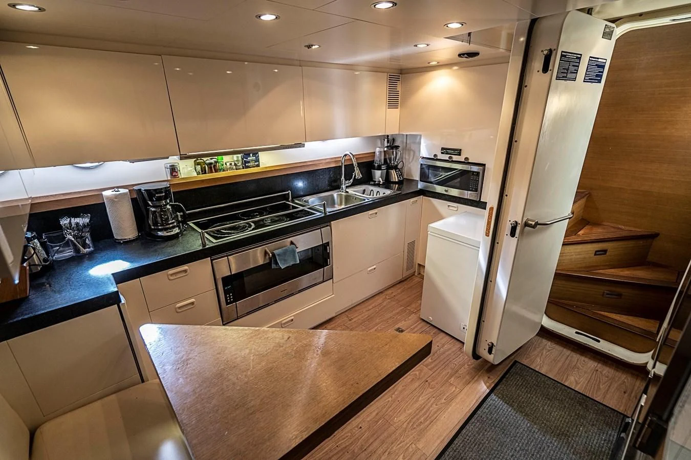a kitchen with a table and oven aboard INTERVENTION Yacht for Sale