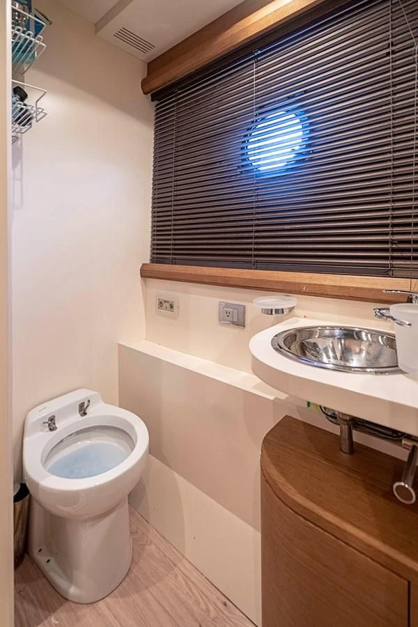 a bathroom with a toilet and sink aboard INTERVENTION Yacht for Sale