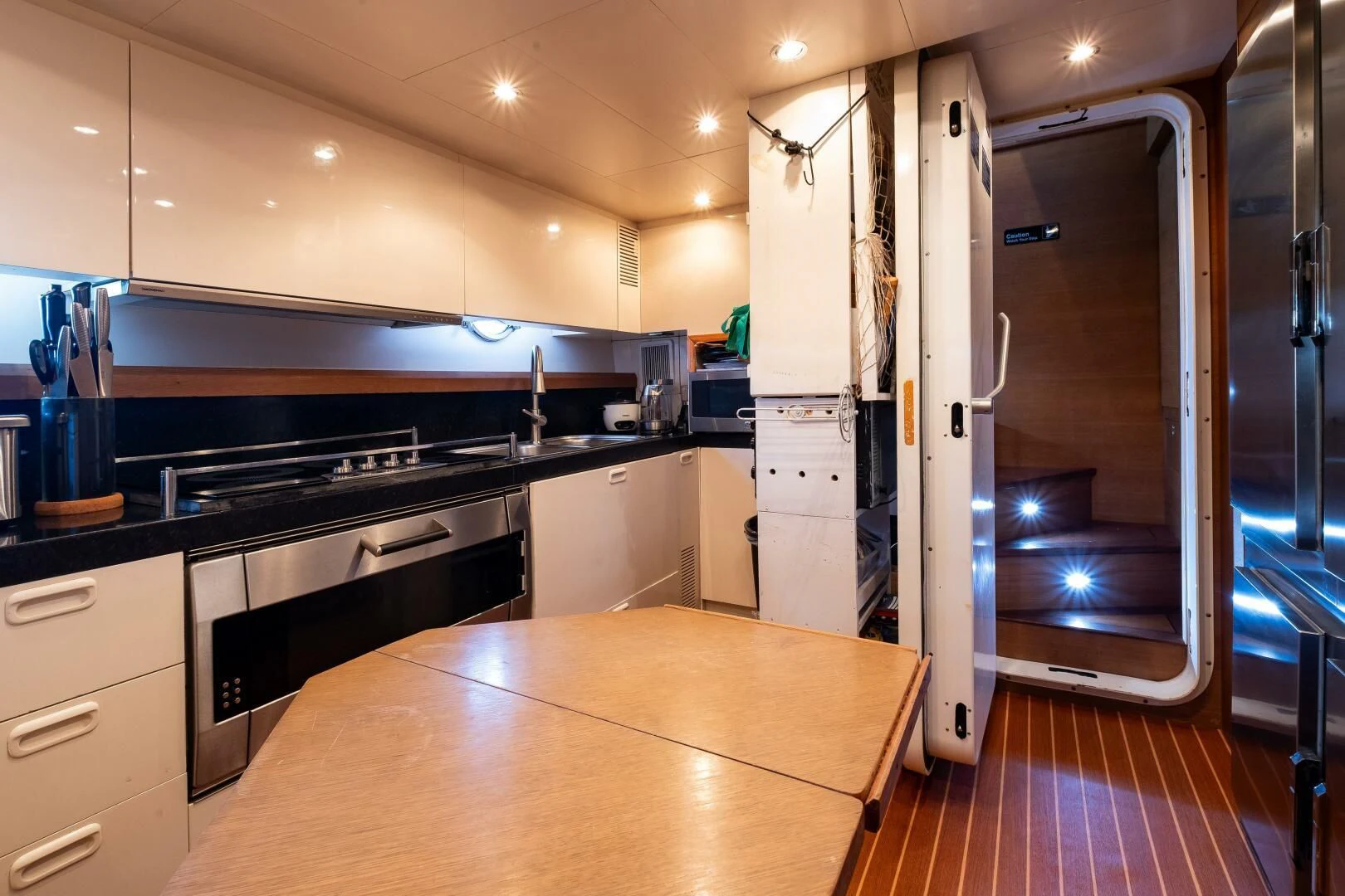 a kitchen with a large refrigerator aboard INTERVENTION Yacht for Sale