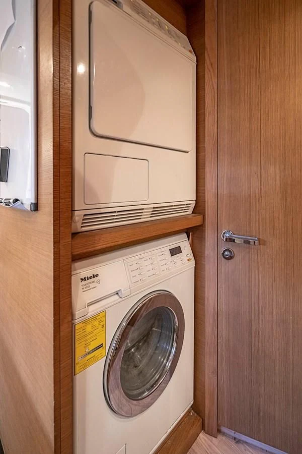 a washer and dryer in a closet aboard INTERVENTION Yacht for Sale