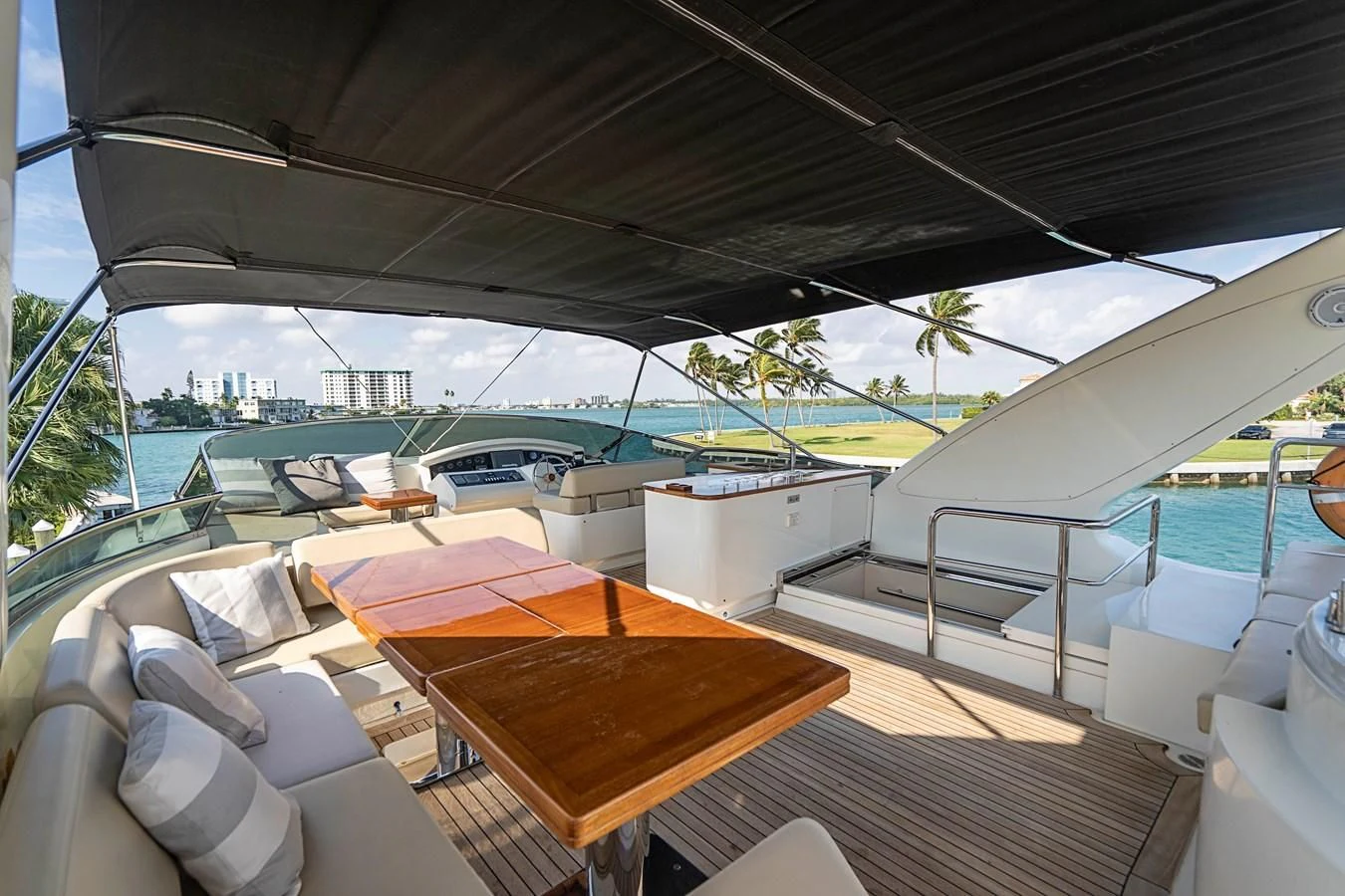 a deck with a table and chairs on it aboard INTERVENTION Yacht for Sale