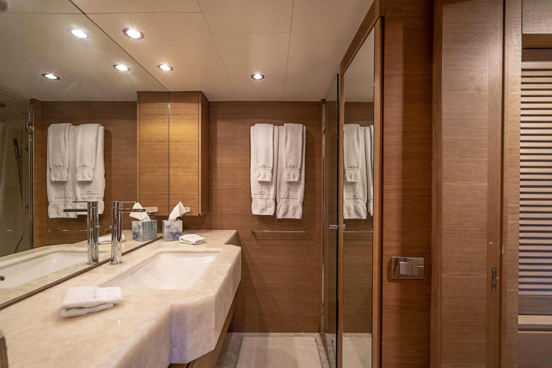 a bathroom with a countertop sink and a shower unit aboard INTERVENTION Yacht for Sale