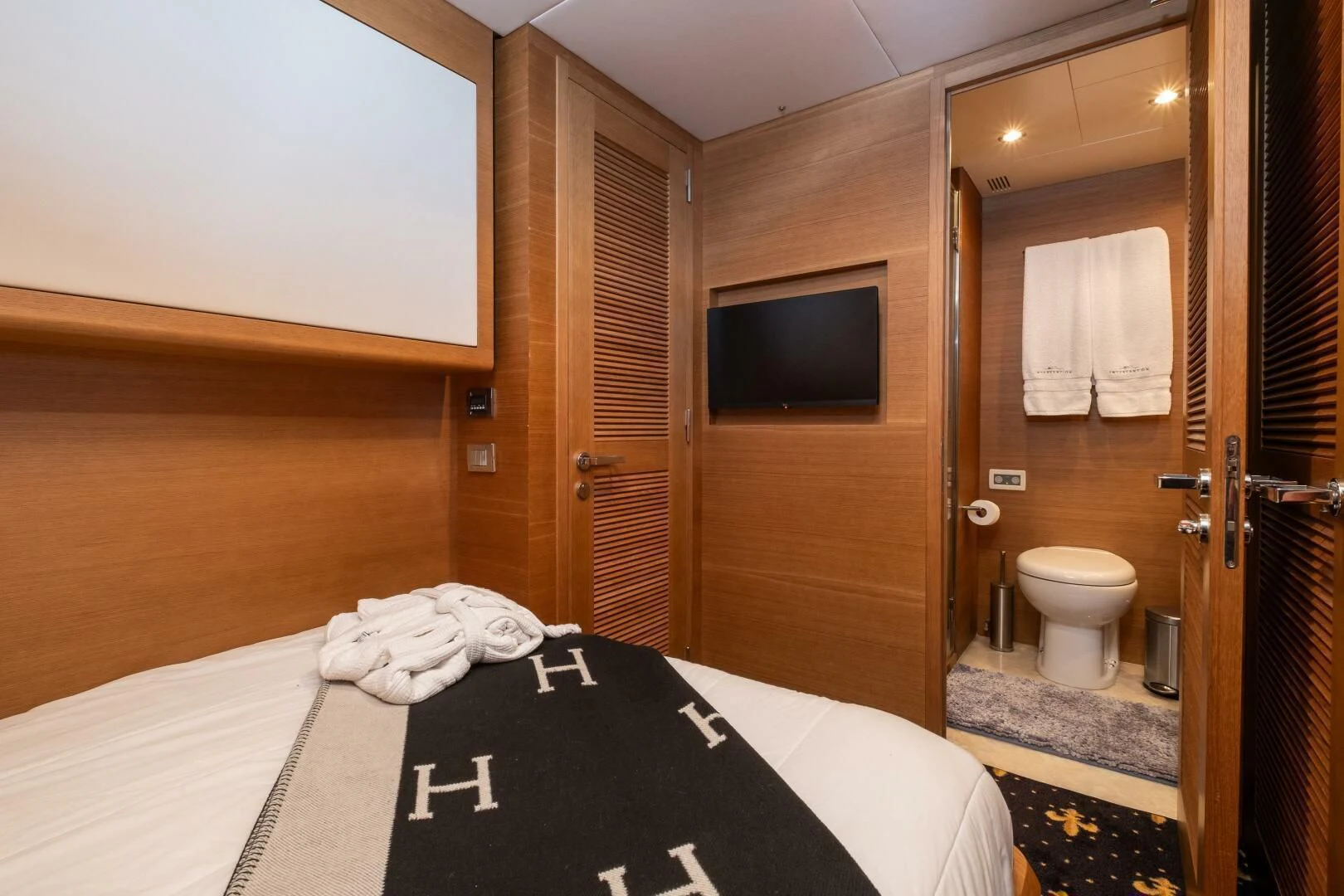a hotel room with a bed and tv aboard INTERVENTION Yacht for Sale