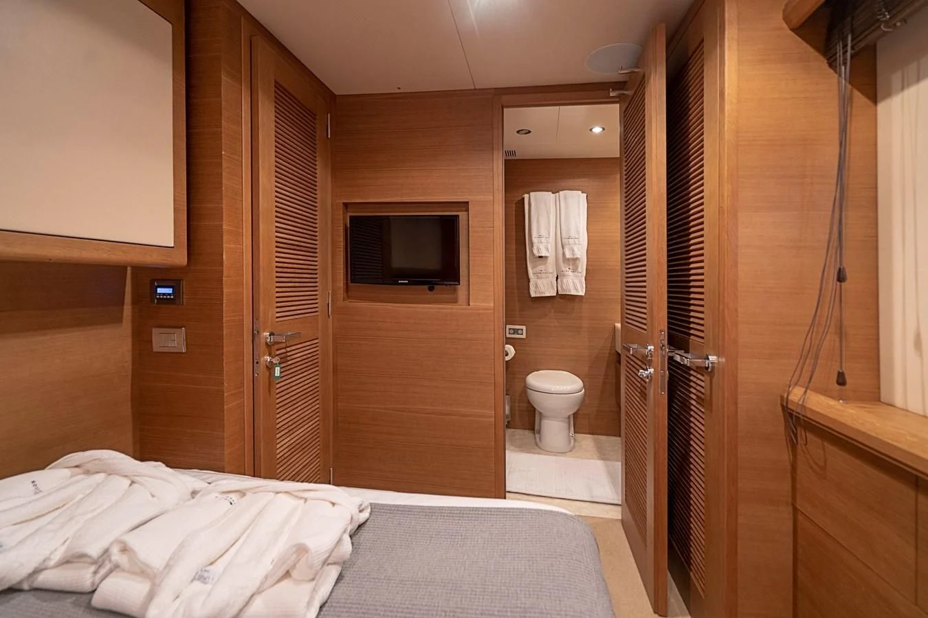 a hotel room with a bed and tv aboard INTERVENTION Yacht for Sale