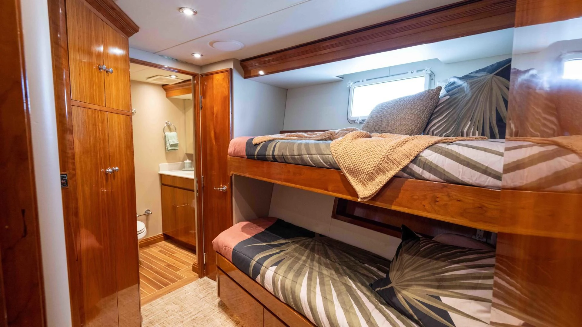 a bed with a wooden frame aboard WELL DONE Yacht for Sale