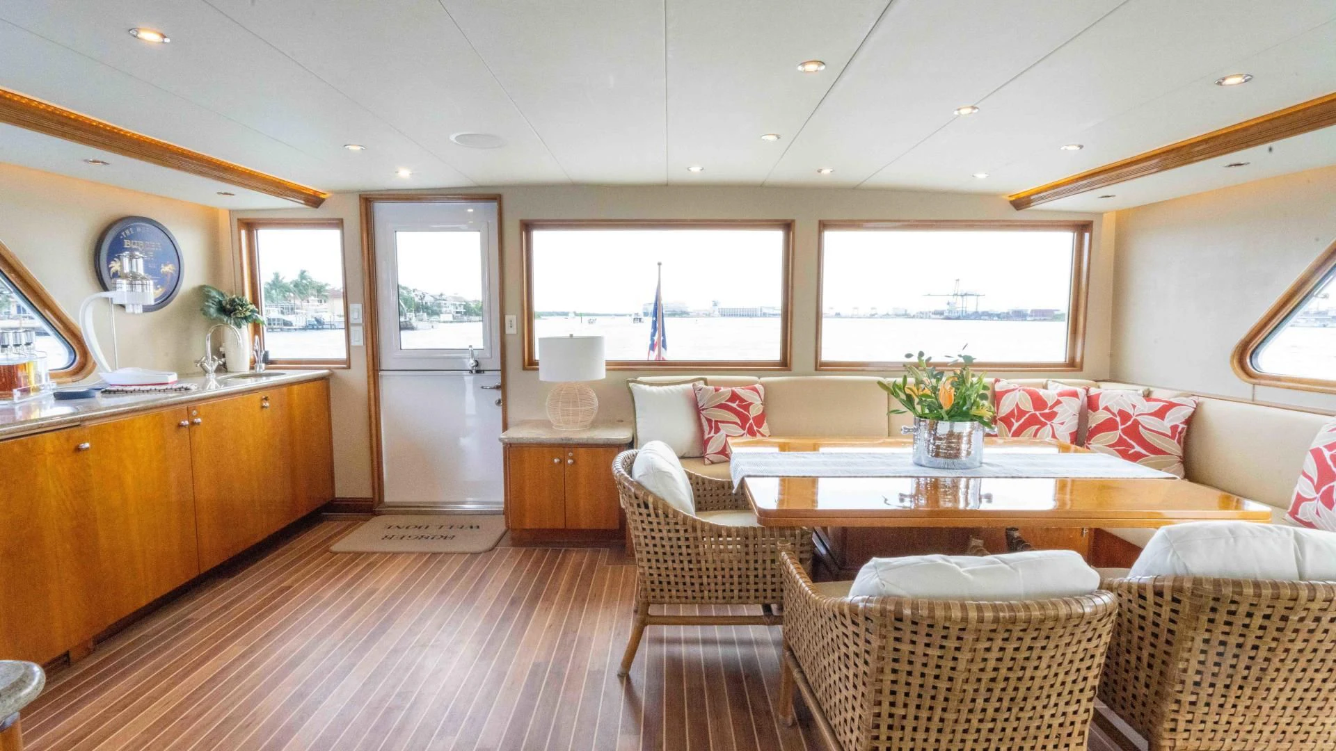 a large living room with a wood floor and a large window aboard WELL DONE Yacht for Sale