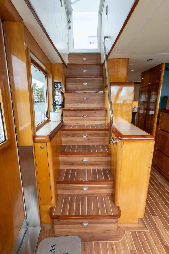 a wooden staircase with a wood railing aboard WELL DONE Yacht for Sale