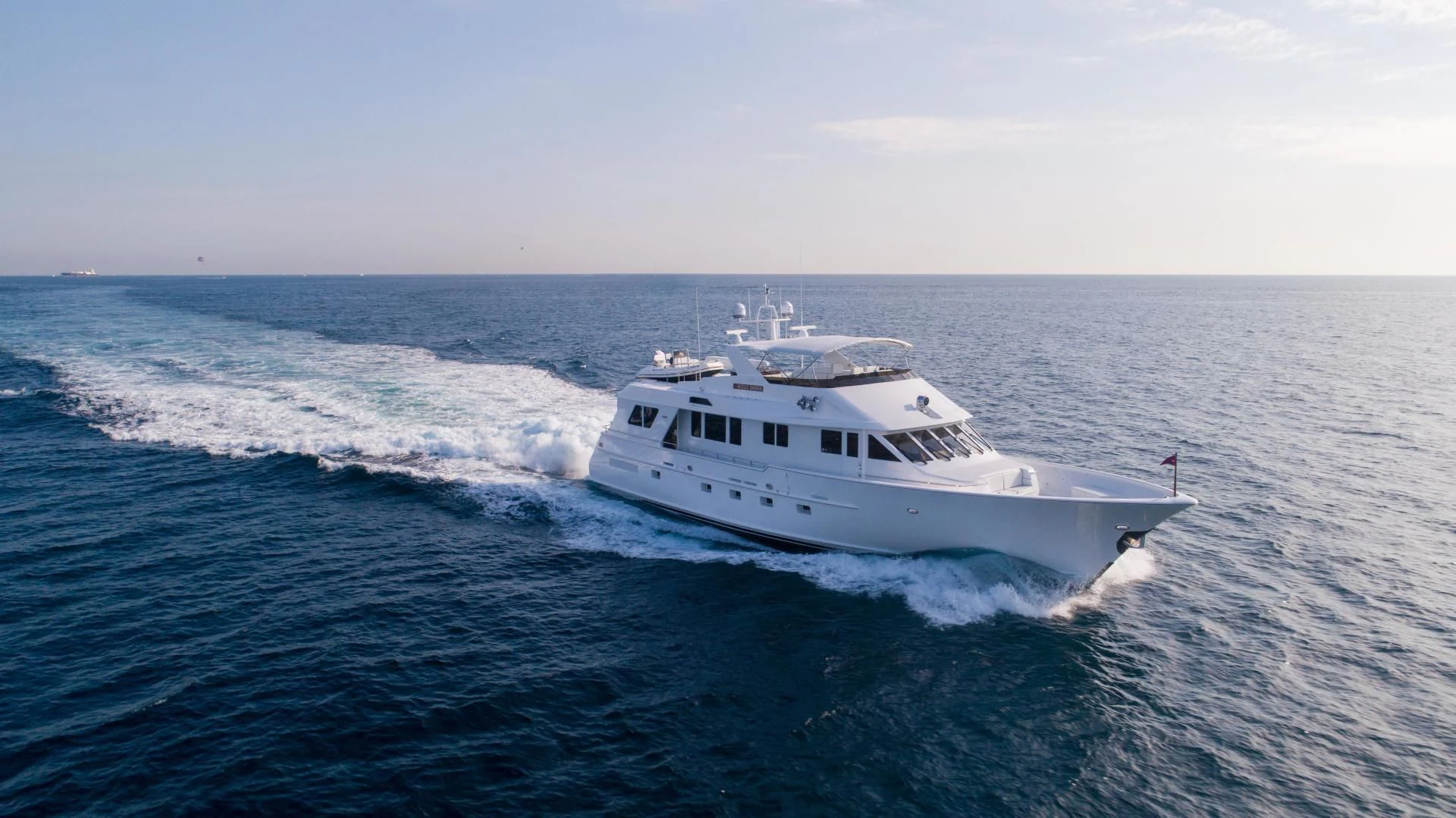 a white boat in the water aboard WELL DONE Yacht for Sale