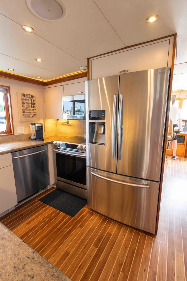 a kitchen with stainless steel appliances aboard WELL DONE Yacht for Sale