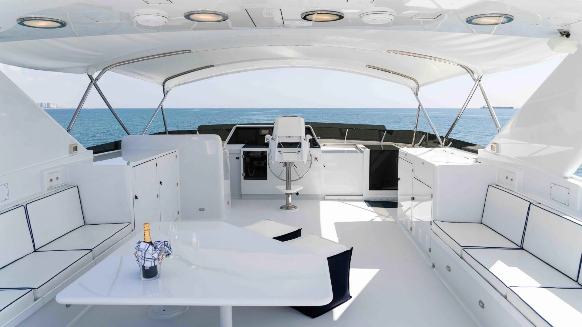 a large white room with a large white table and chairs aboard WELL DONE Yacht for Sale