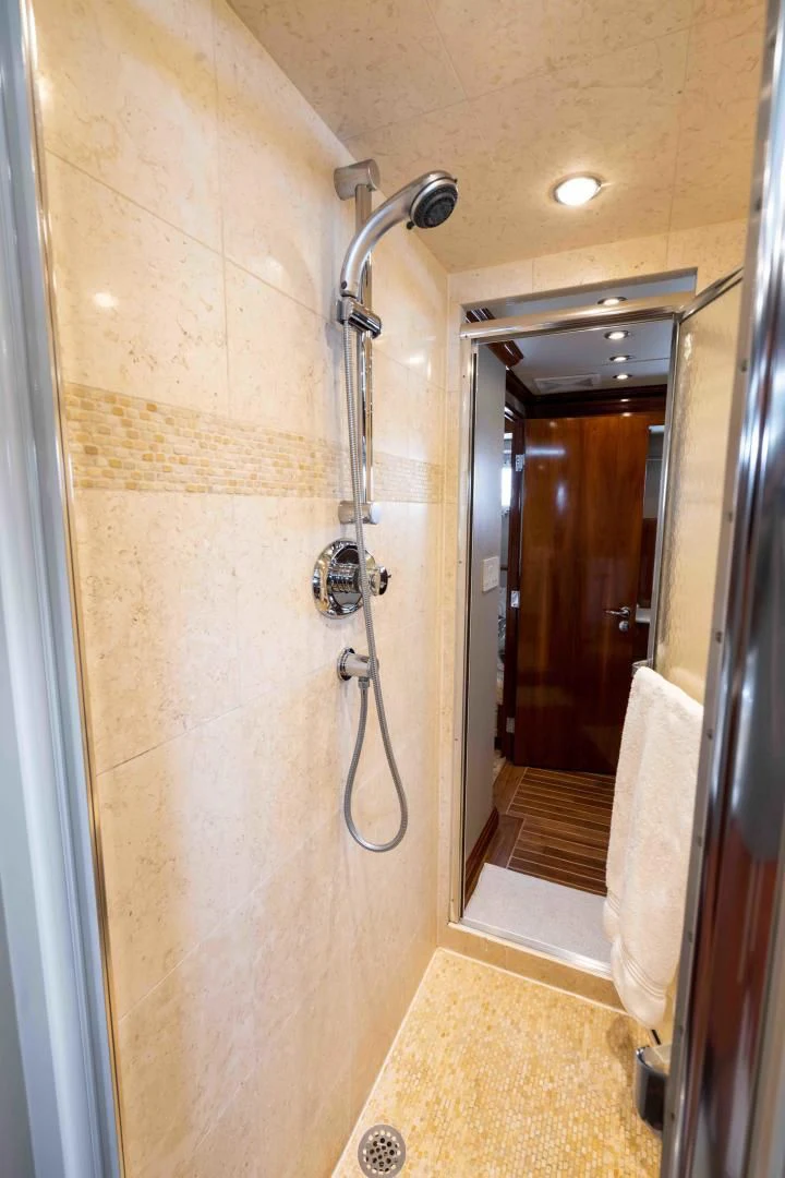 a bathroom with a shower and a sink aboard WELL DONE Yacht for Sale