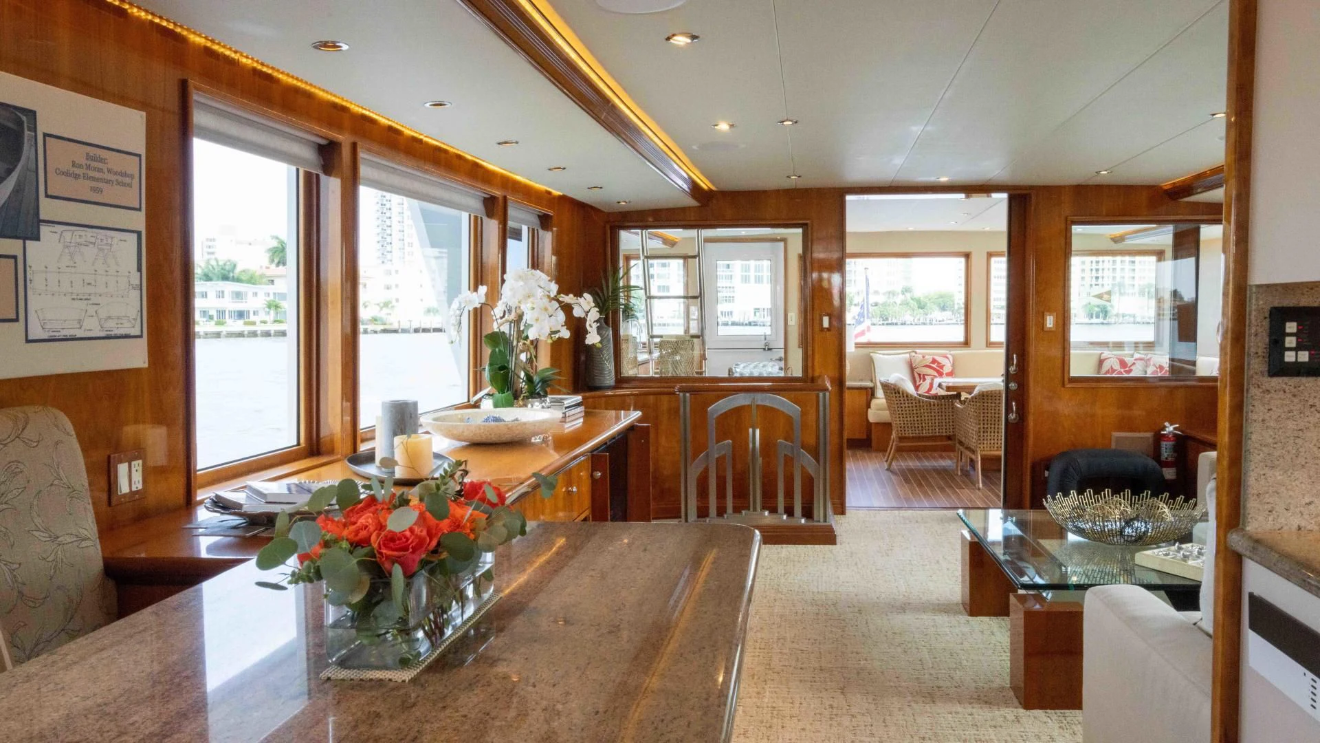a large living room with a table and chairs aboard WELL DONE Yacht for Sale
