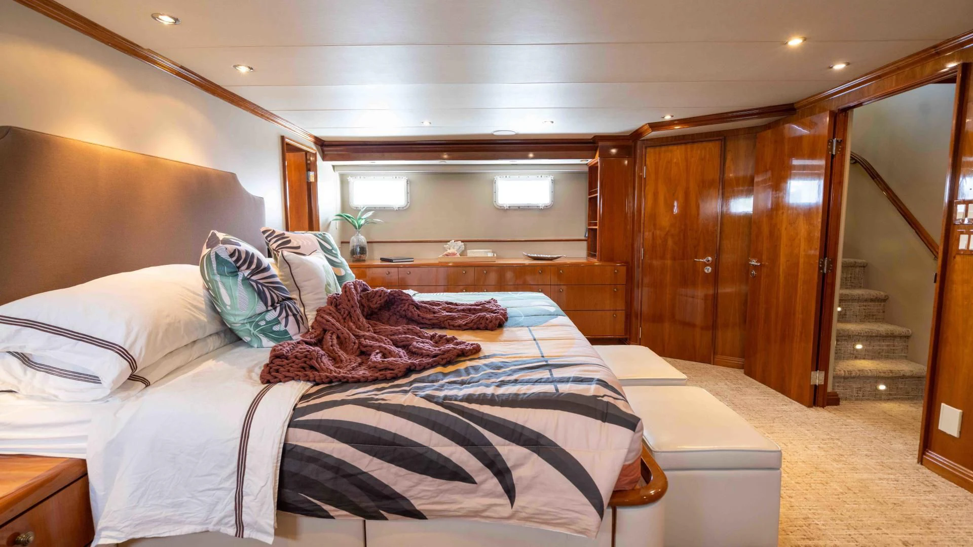 a room with a bed and a wood door aboard WELL DONE Yacht for Sale