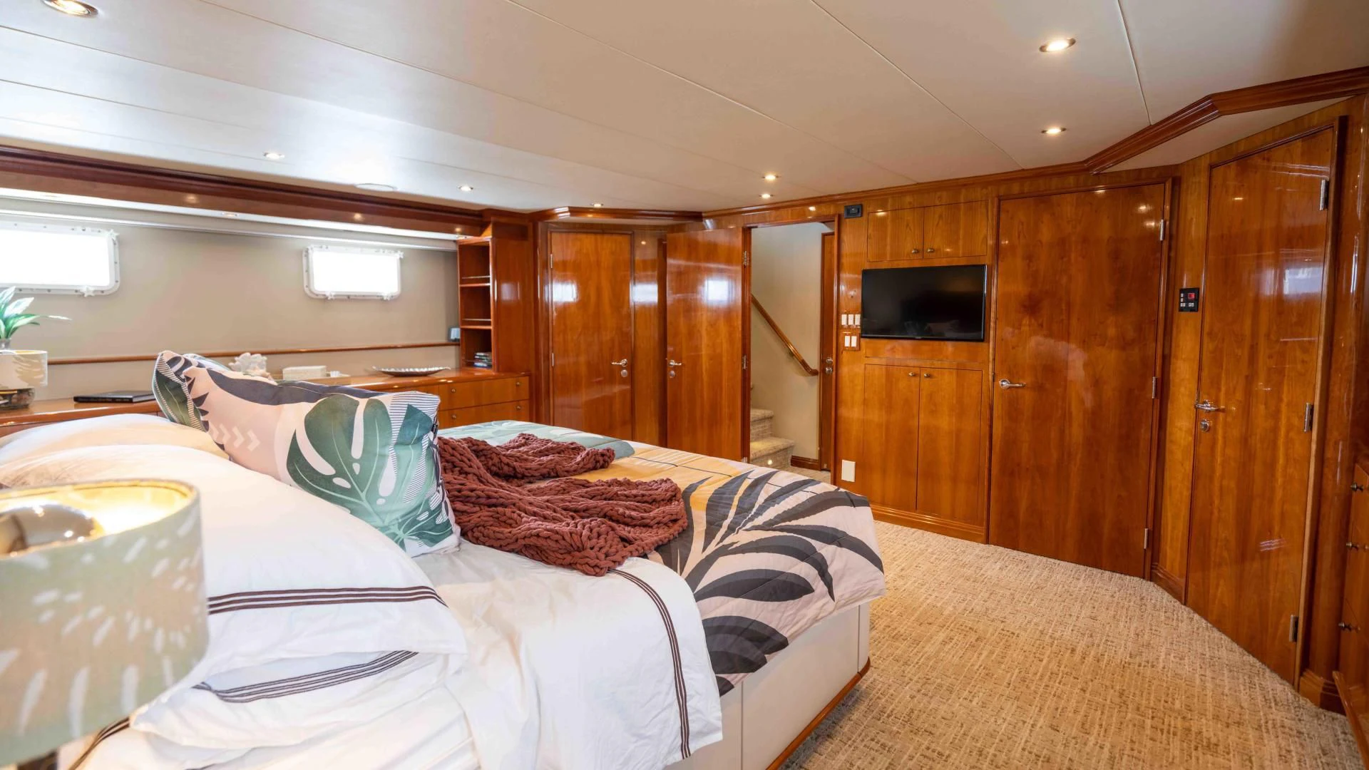 a bedroom with a bed and a television aboard WELL DONE Yacht for Sale