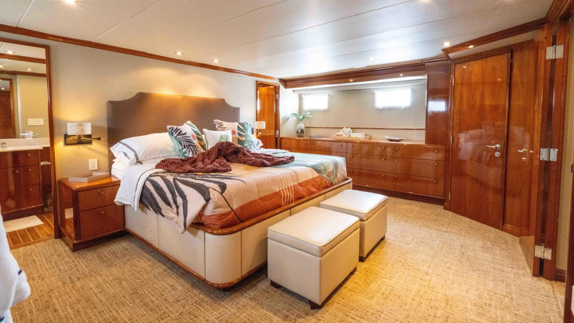 a bedroom with a bed and a desk aboard WELL DONE Yacht for Sale