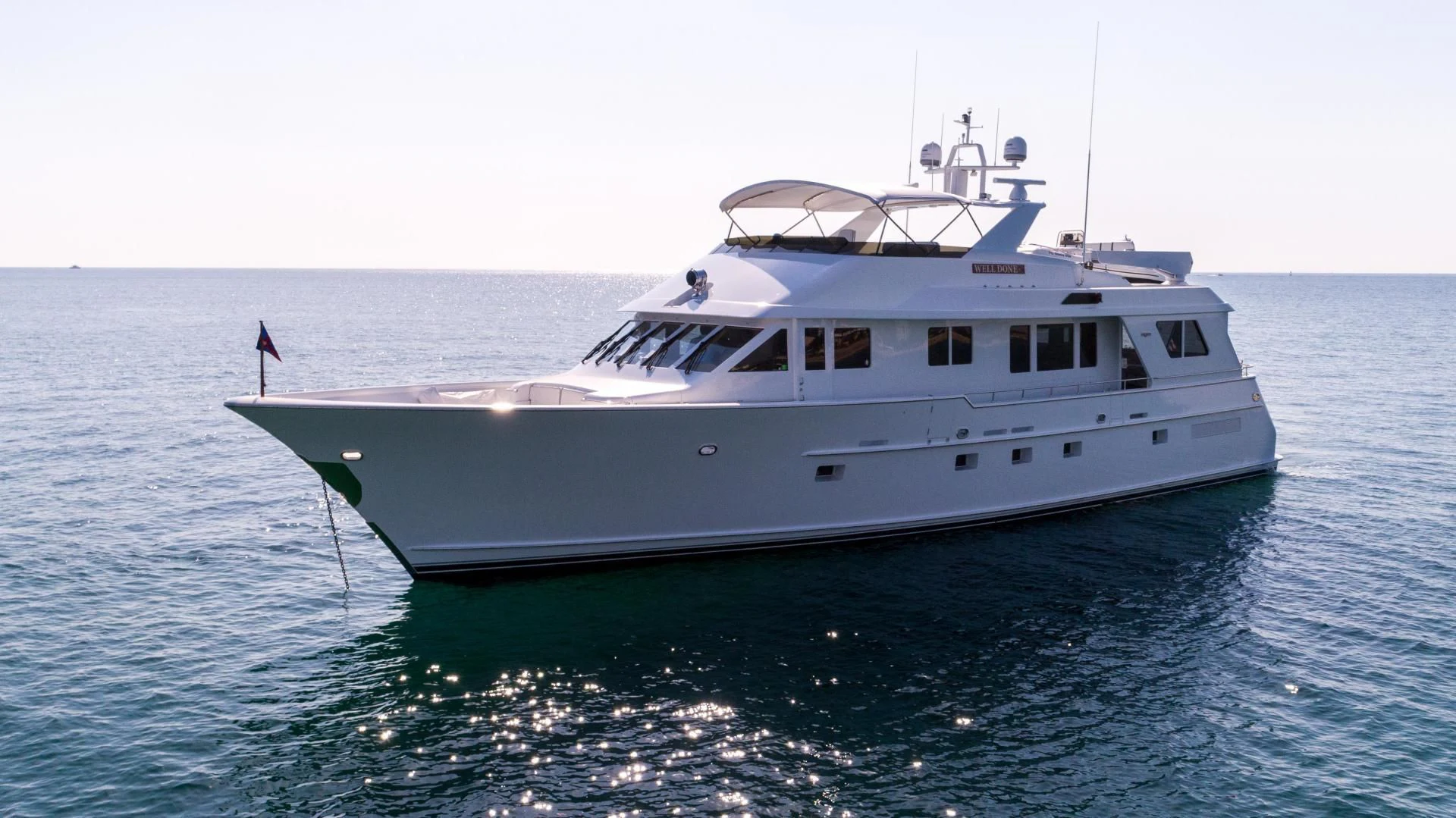 a white boat in the water aboard WELL DONE Yacht for Sale