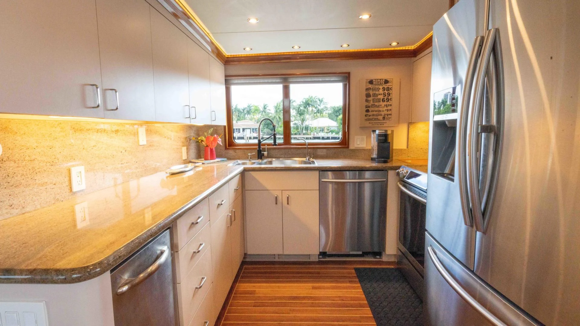 a kitchen with a stainless steel refrigerator aboard WELL DONE Yacht for Sale