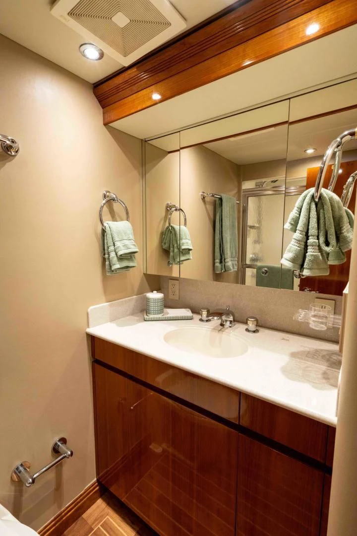 a bathroom with a large mirror aboard WELL DONE Yacht for Sale
