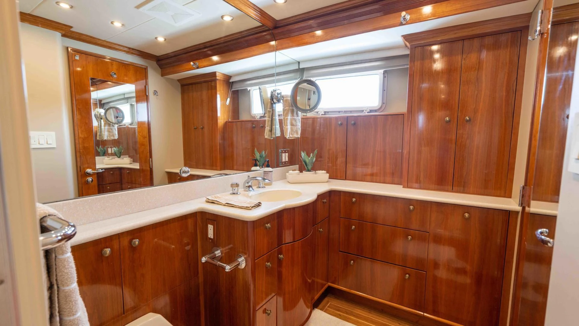 a bathroom with wooden cabinets aboard WELL DONE Yacht for Sale
