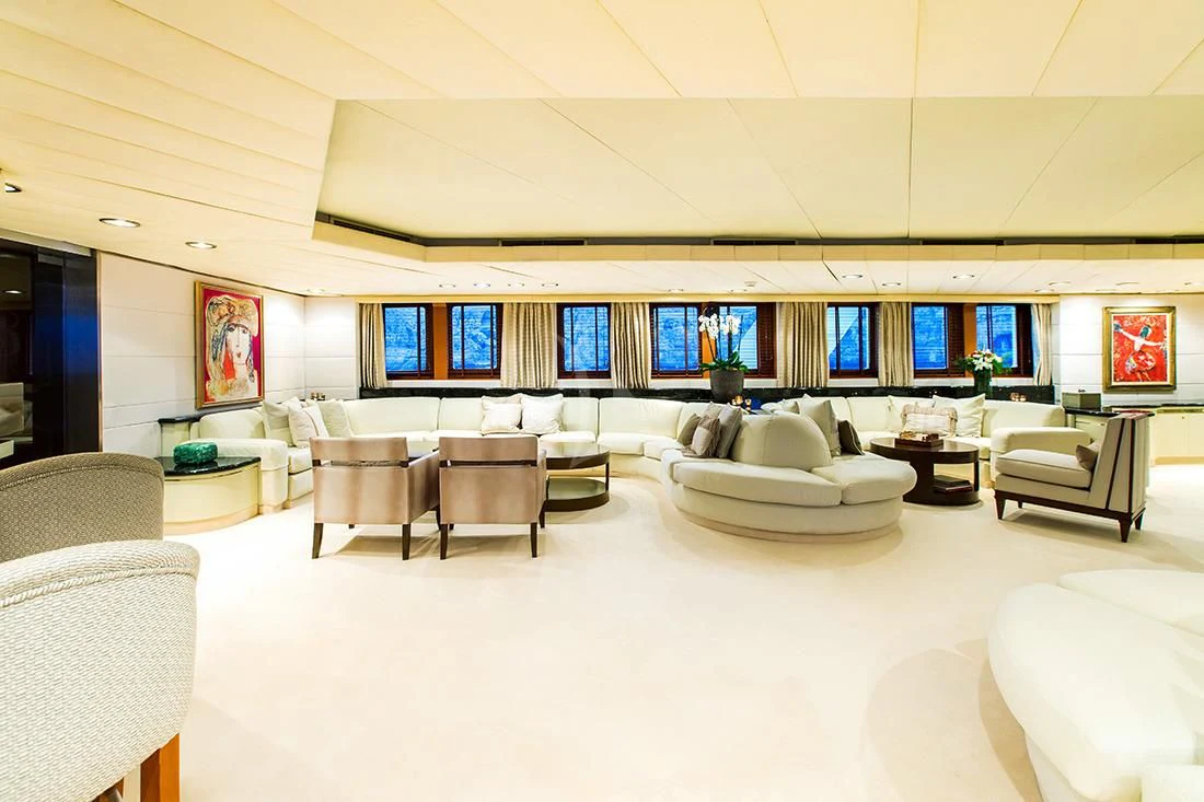 a room with white chairs and a large screen aboard ESMERALDA Yacht for Sale