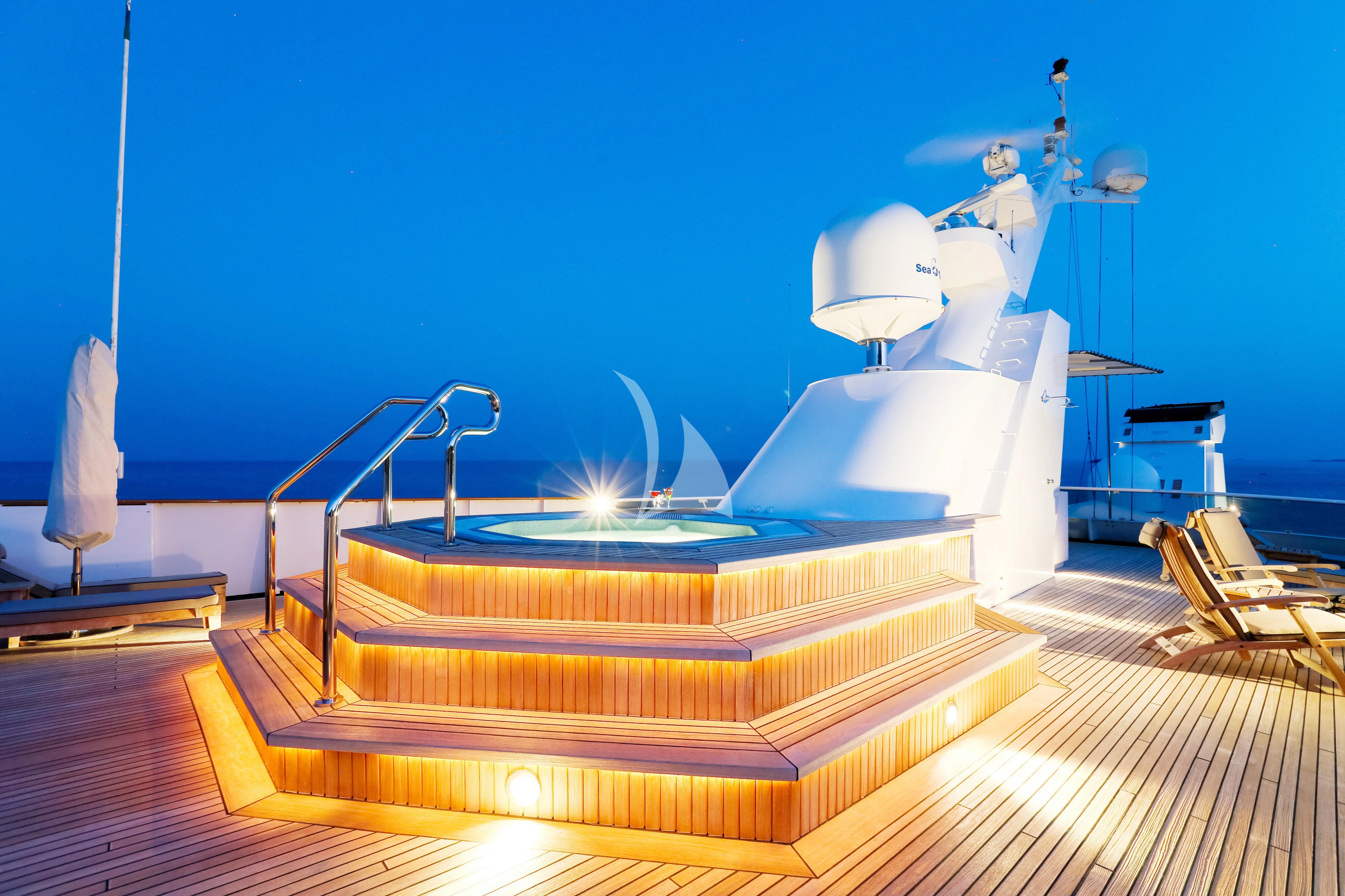 a large white boat with a person on top aboard ESMERALDA Yacht for Sale