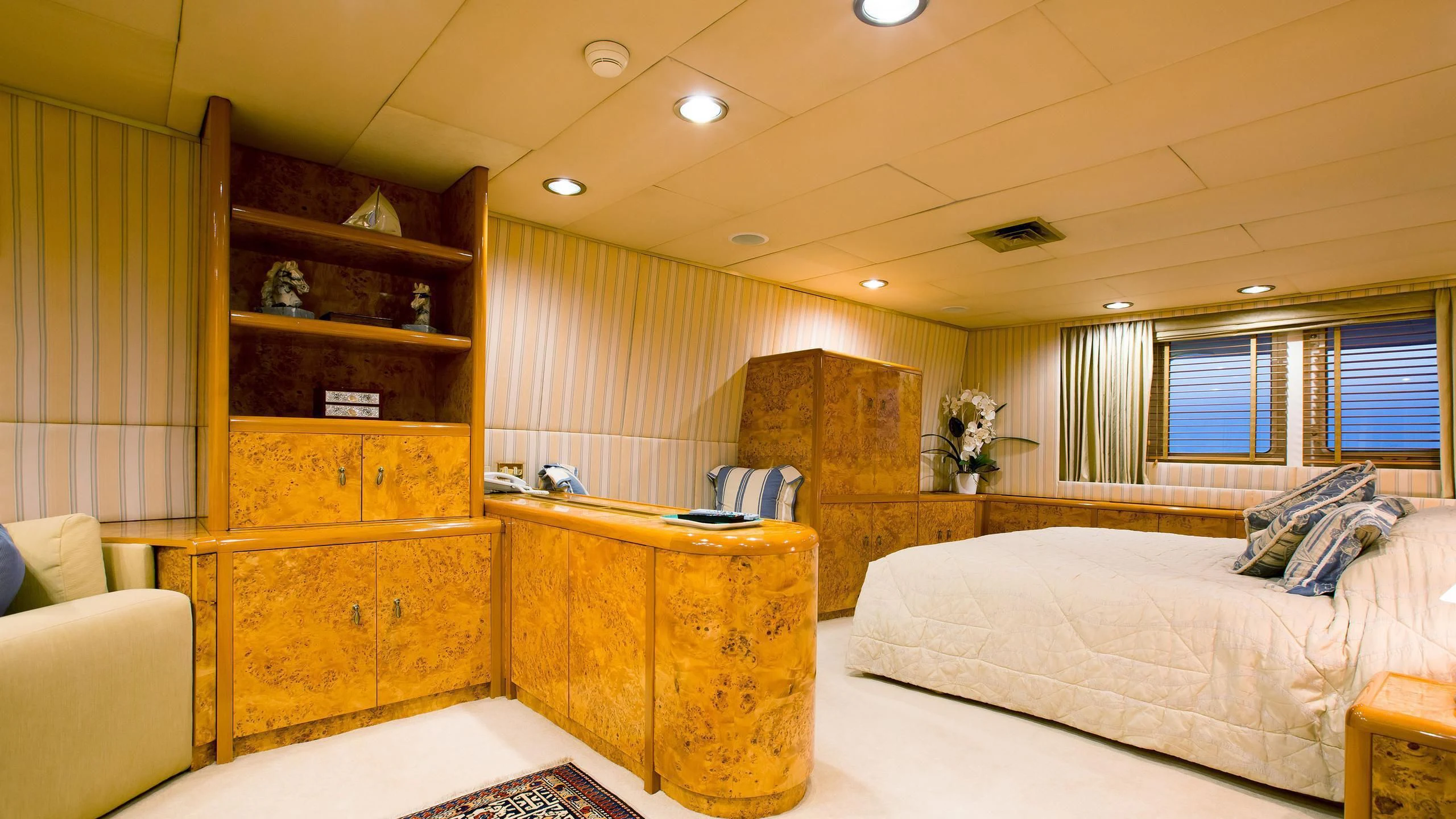 a bedroom with a bed and a desk aboard ESMERALDA Yacht for Sale