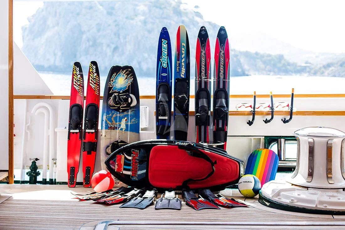 a group of skateboards and a helmet on a table aboard ESMERALDA Yacht for Sale