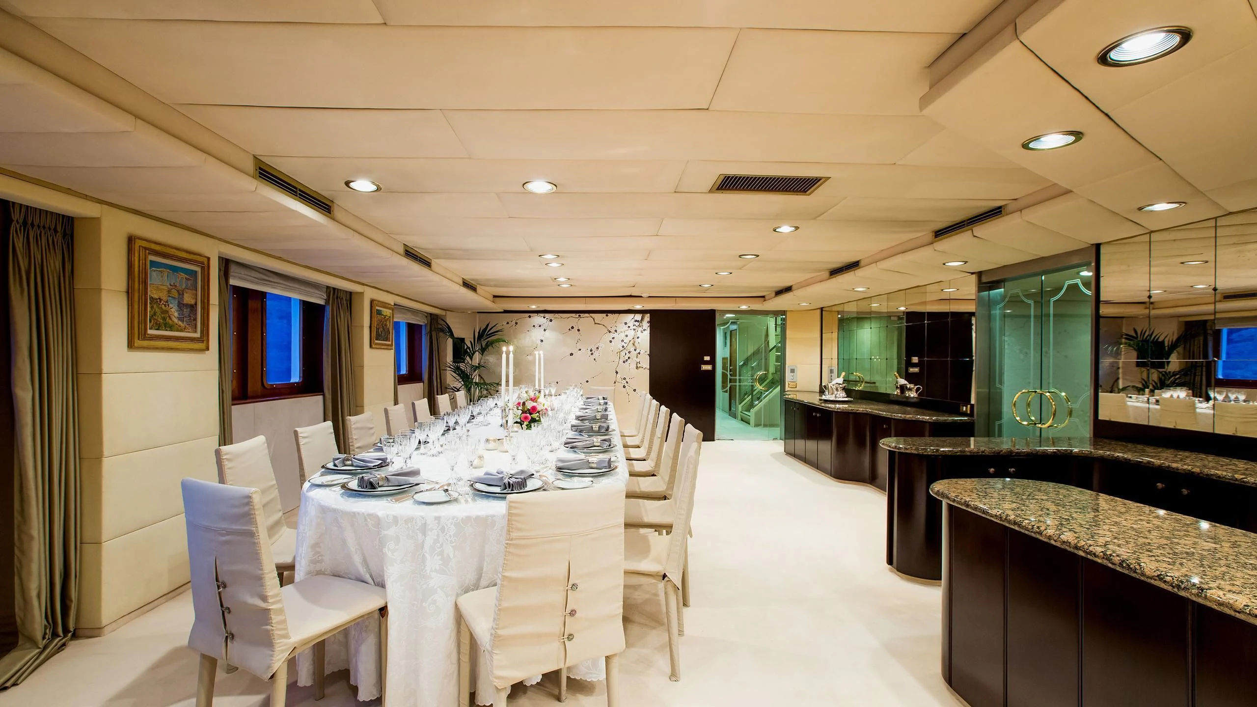 a room with tables and chairs aboard ESMERALDA Yacht for Sale