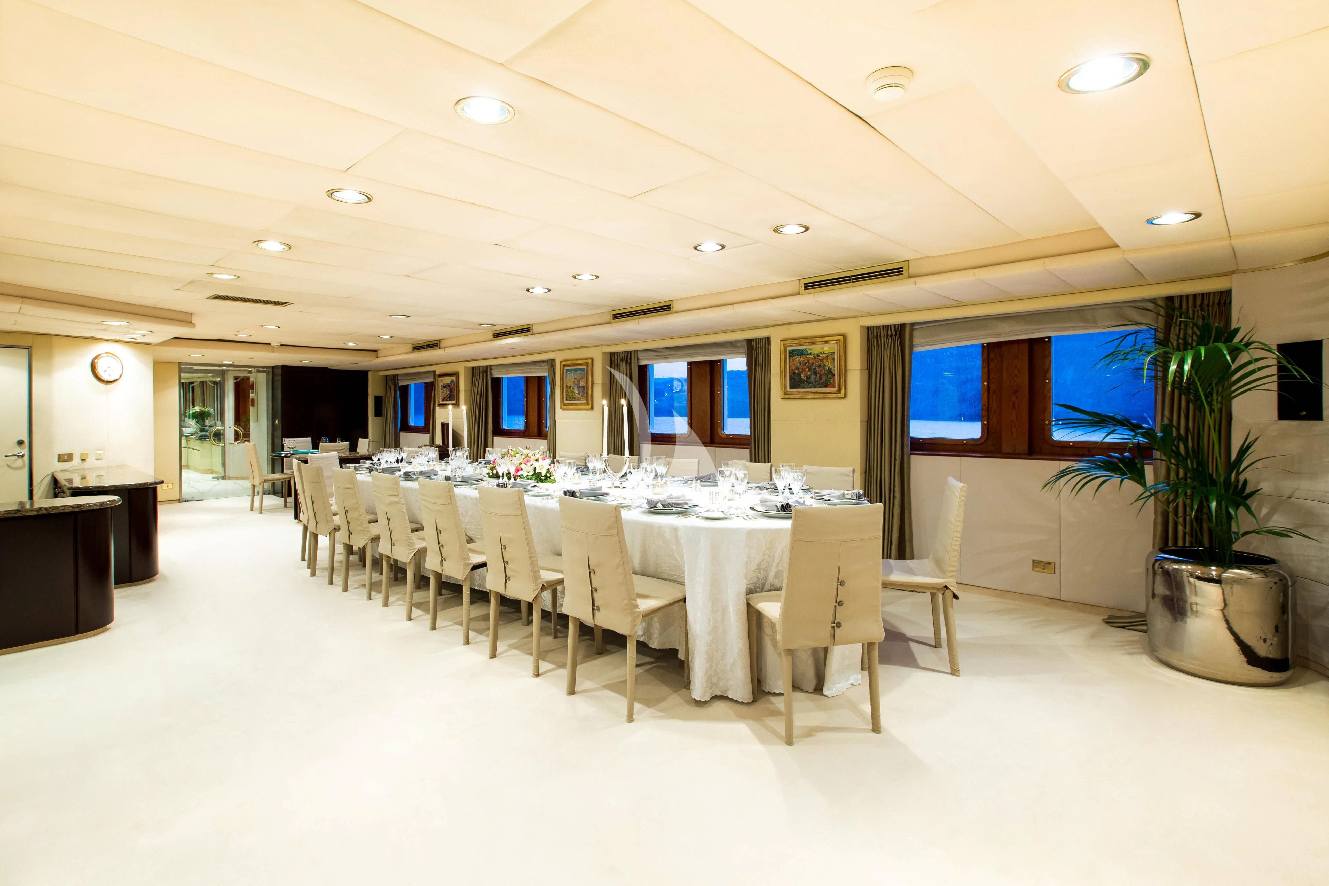 a large room with tables and chairs aboard ESMERALDA Yacht for Sale