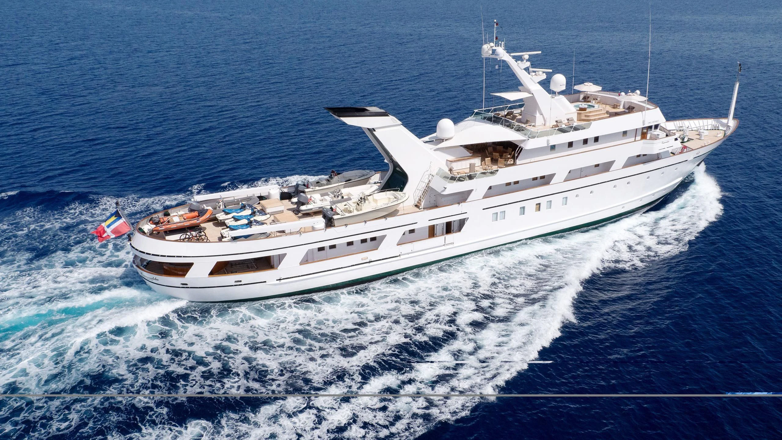 a white yacht in the ocean aboard ESMERALDA Yacht for Sale