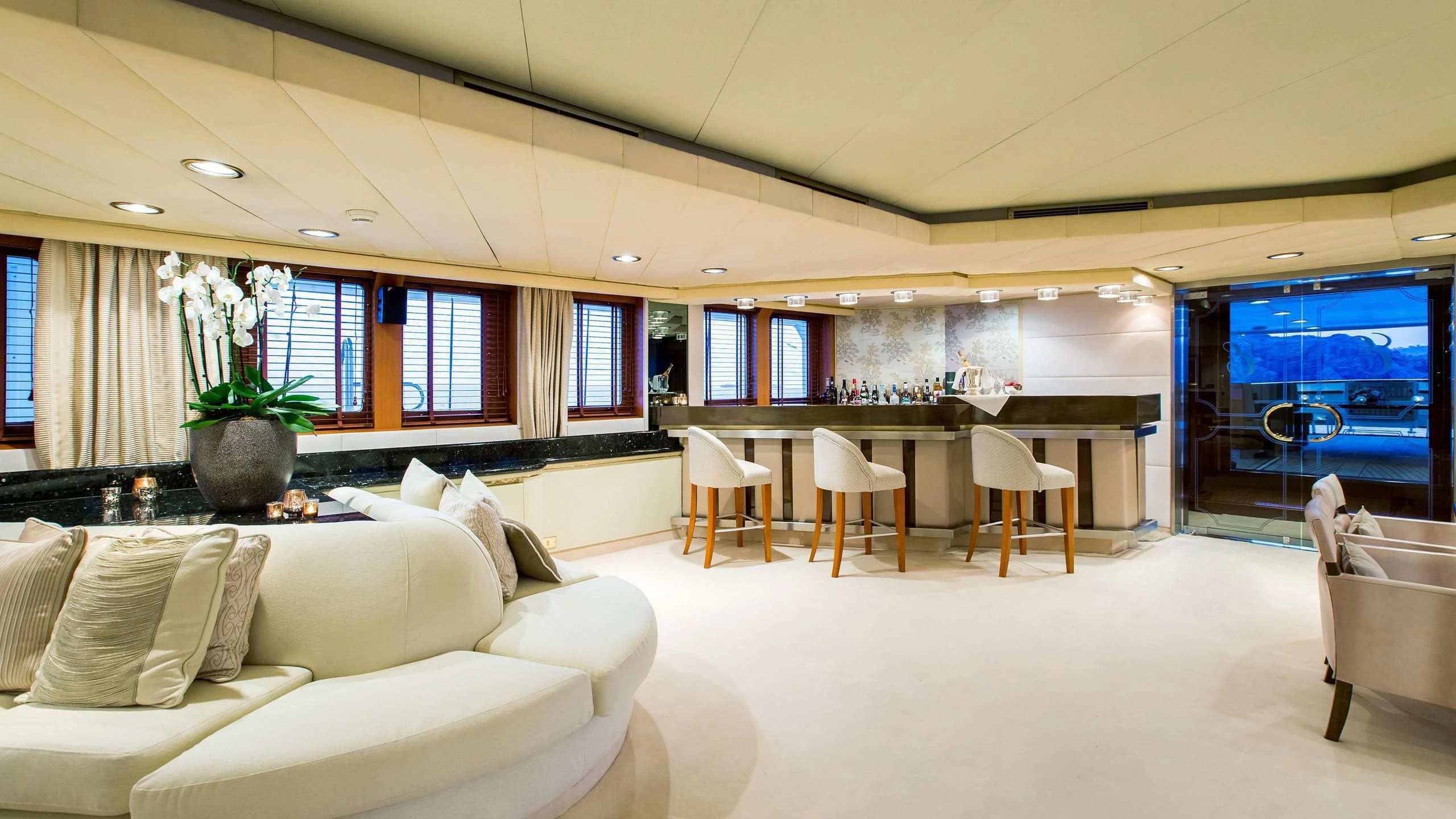 a large living room with white furniture aboard ESMERALDA Yacht for Sale