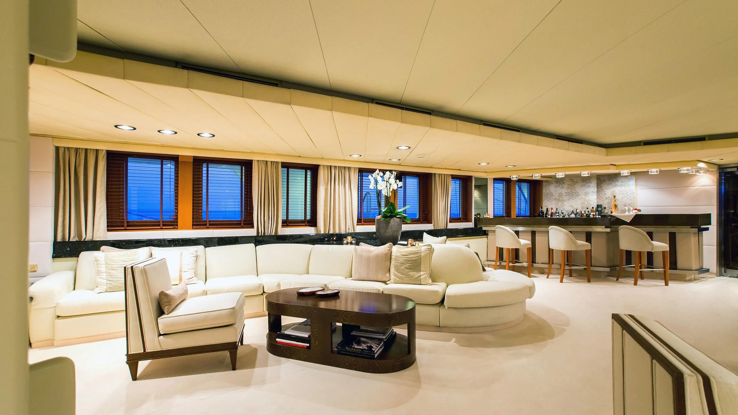 a large living room with a large window aboard ESMERALDA Yacht for Sale