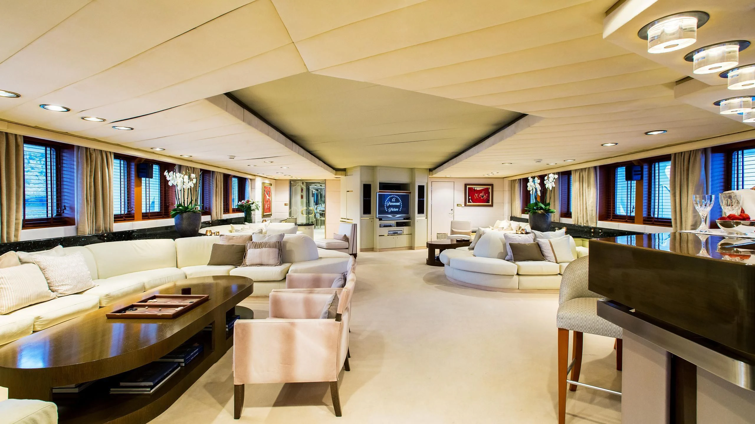 a large living room with a large window aboard ESMERALDA Yacht for Sale