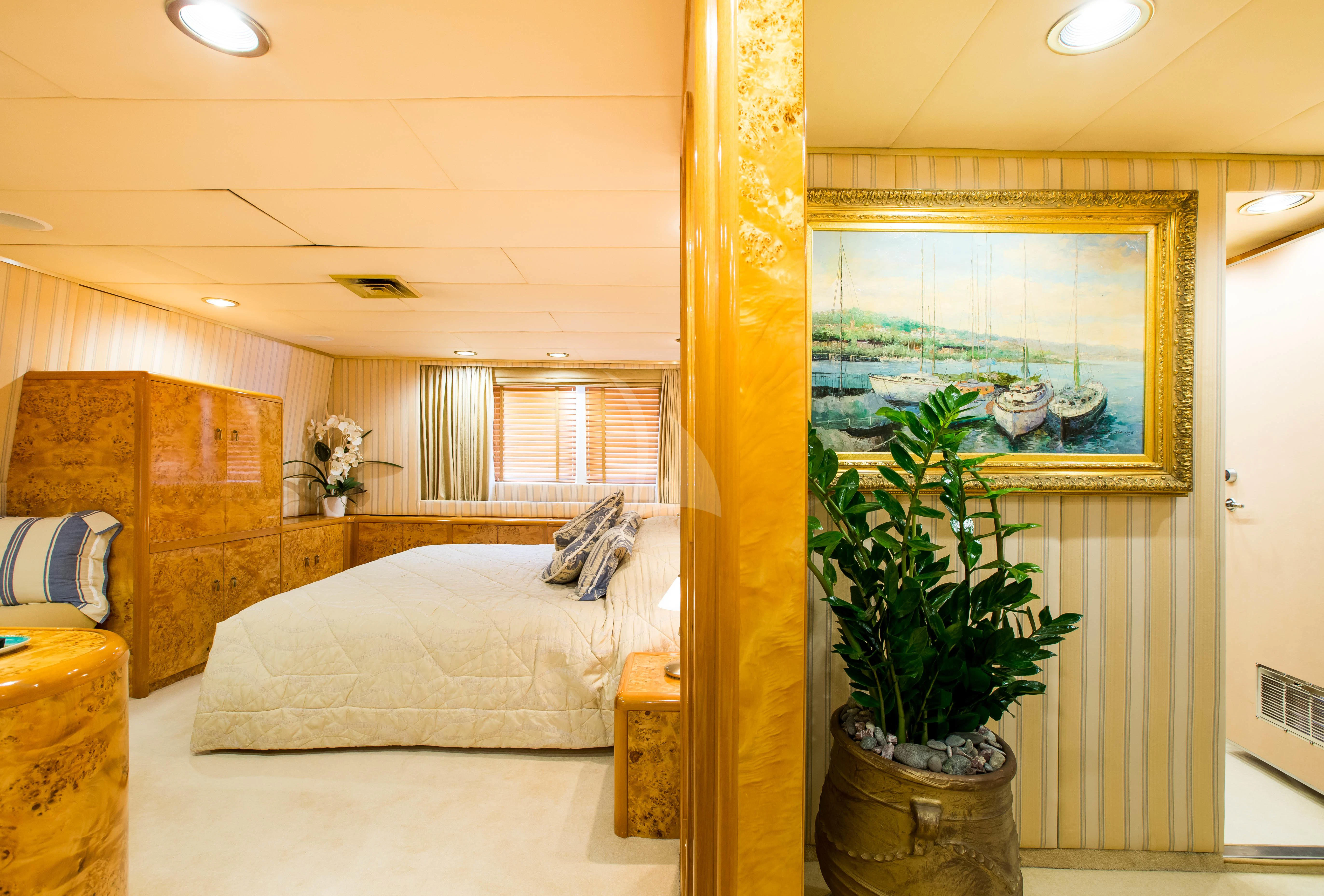 a bedroom with a bed and a plant aboard ESMERALDA Yacht for Sale